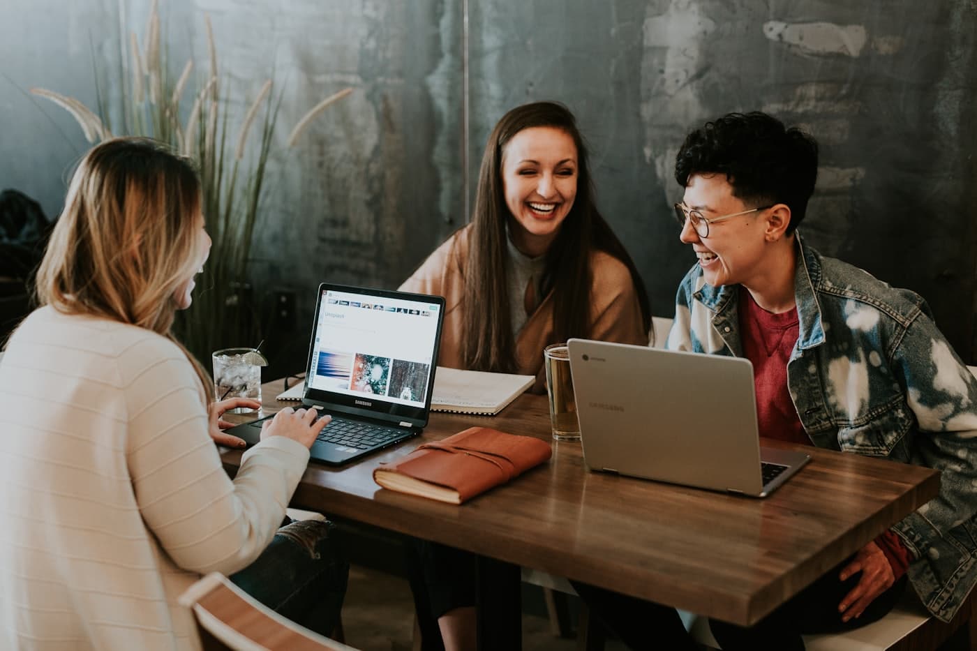 Small team discussing work around a laptop